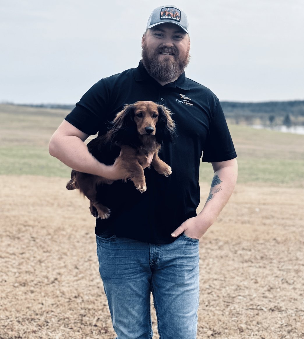 Will Brown, owner of Zippy Scoops, holding a dog